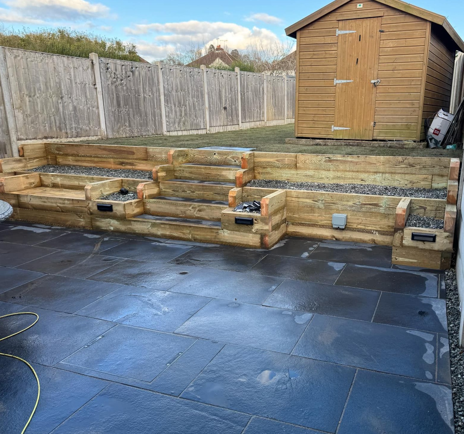 Limestone patio and sleeper wall with steps